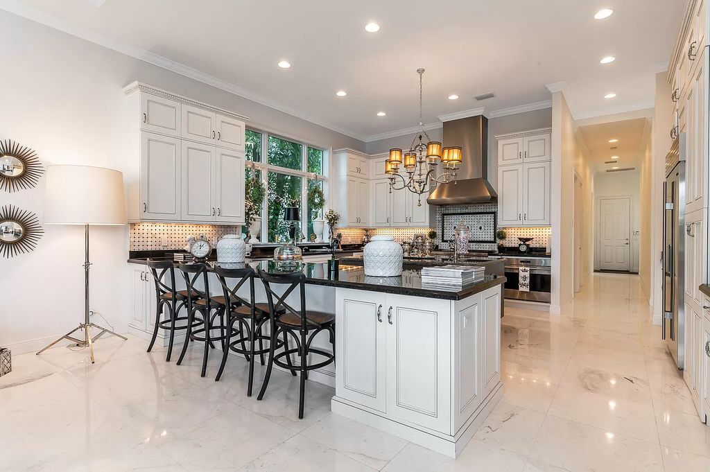 The Boca Raton Home, a smart residence is located on a premium lot overlooking the grand lake and features a breathtaking backyard is now available for sale. This home located at 9099 Redonda Dr, Boca Raton, Florida