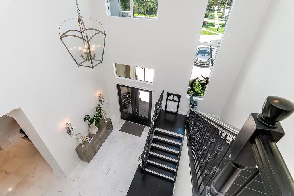 The Boca Raton Home, a smart residence is located on a premium lot overlooking the grand lake and features a breathtaking backyard is now available for sale. This home located at 9099 Redonda Dr, Boca Raton, Florida