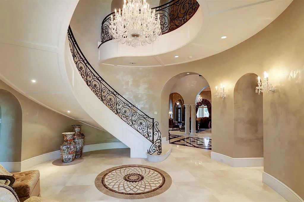 The Home in Sugar Land, a world class architectural masterpiece inspired by Europe's great estates offers endless lifestyle with opulent formals for entertaining, a gorgeous kitchen, wellness gym, two game rooms, wet bars, media room and other entertainment amenities is now available for sale. This home located at 11 Paradise Point Dr, Sugar Land, Texas