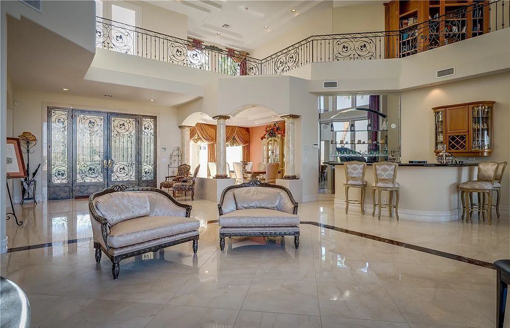 The Home in Henderson, an elegant Terracina estate with classic finishes in a prestigious guard-gated community offers panoramic mountain, sprawling golf course, city, and Strip views is now available for sale. This home located at 2608 Ragusa Ct, Henderson, Nevada