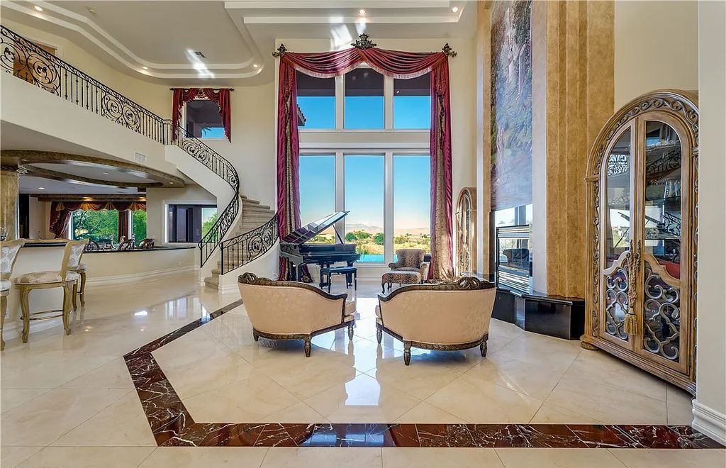 The Home in Henderson, an elegant Terracina estate with classic finishes in a prestigious guard-gated community offers panoramic mountain, sprawling golf course, city, and Strip views is now available for sale. This home located at 2608 Ragusa Ct, Henderson, Nevada