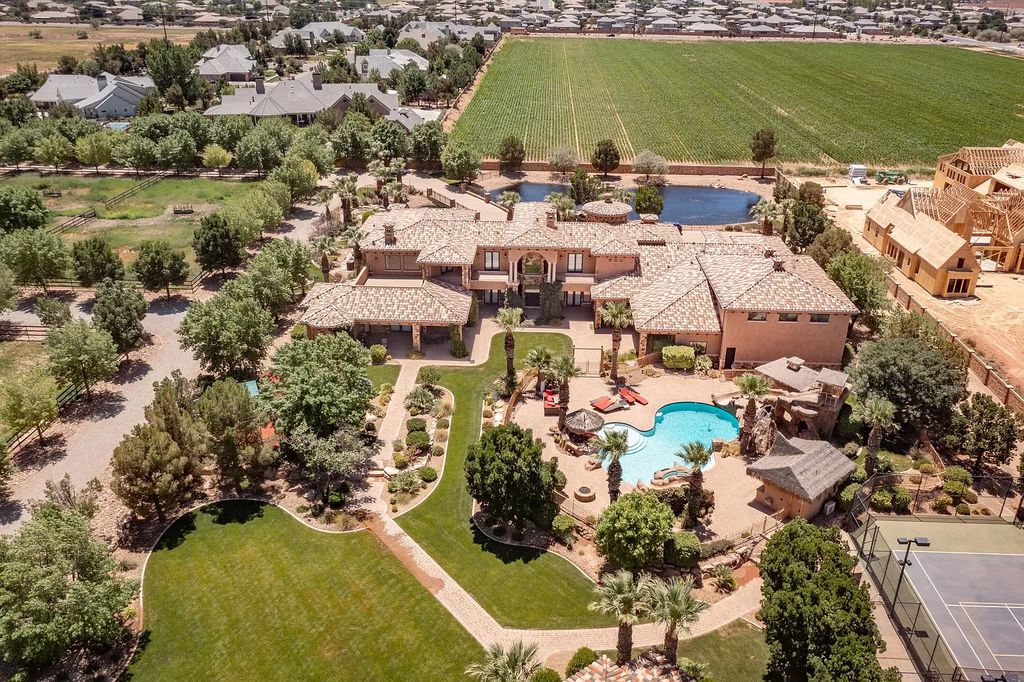 The Estate in Washington, a luxurious home with over 0.5 acre pond plenty of space for parking offering resort style pool, full sports court, theatre room, indoor gym, full bar, pavillion & indoor basketball court and  is now available for sale. This home located at 90 W Triple Crown Ln, Washington, Utah