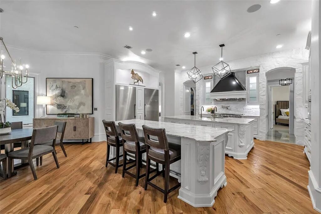 The Home in Frisco, an extraordinary modified Tudor style custom estate offers multiple spaces for entertaining and luxury amenities including onsite splash pad, pool and spa, two story terrace with balcony, theater room, game room, wine cellar and more is now available for sale. This home located at 6267 Sweeney Trl, Frisco, Texas