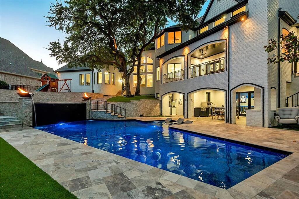 The Home in Frisco, an extraordinary modified Tudor style custom estate offers multiple spaces for entertaining and luxury amenities including onsite splash pad, pool and spa, two story terrace with balcony, theater room, game room, wine cellar and more is now available for sale. This home located at 6267 Sweeney Trl, Frisco, Texas