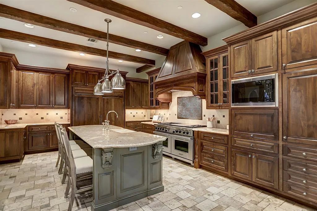 The Estate in Houston, a breathtaking home has loads of curb appeal with meticulously maintained grounds, elegant sconces, and stunning red brick, captivating backyard perfect for entertaining is now available for sale. This home located at 11320 Green Vale Dr, Houston, Texas