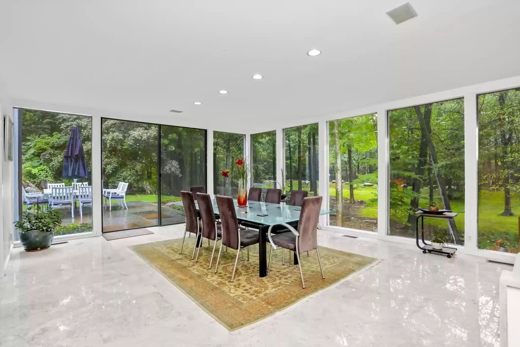 The House in Greenwich blends the verdant outdoors with open living spaces flooded with sunlight, now available for sale. This home located at 48 Lafrentz Rd, Greenwich, Connecticut