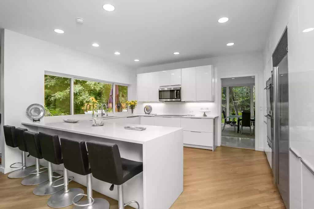 The House in Greenwich blends the verdant outdoors with open living spaces flooded with sunlight, now available for sale. This home located at 48 Lafrentz Rd, Greenwich, Connecticut