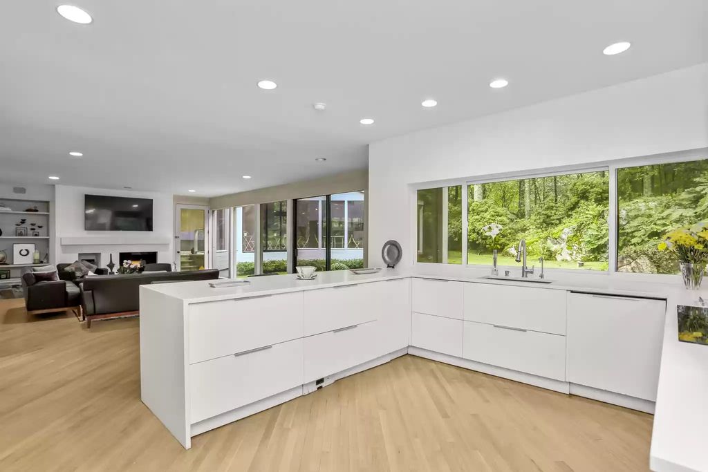 The House in Greenwich blends the verdant outdoors with open living spaces flooded with sunlight, now available for sale. This home located at 48 Lafrentz Rd, Greenwich, Connecticut