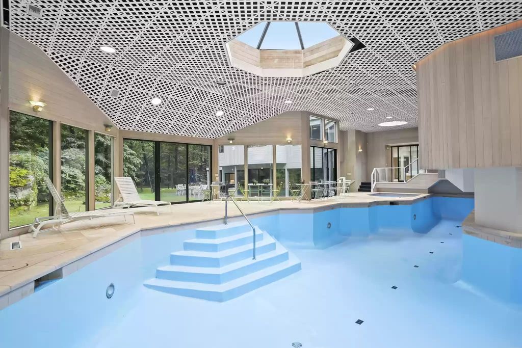 The House in Greenwich blends the verdant outdoors with open living spaces flooded with sunlight, now available for sale. This home located at 48 Lafrentz Rd, Greenwich, Connecticut
