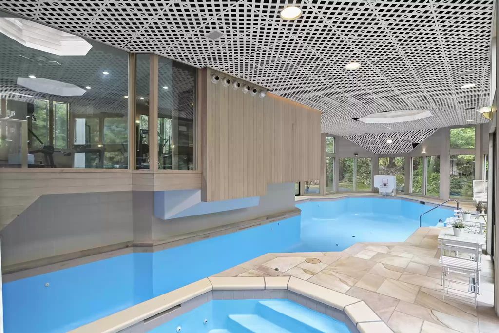 The House in Greenwich blends the verdant outdoors with open living spaces flooded with sunlight, now available for sale. This home located at 48 Lafrentz Rd, Greenwich, Connecticut