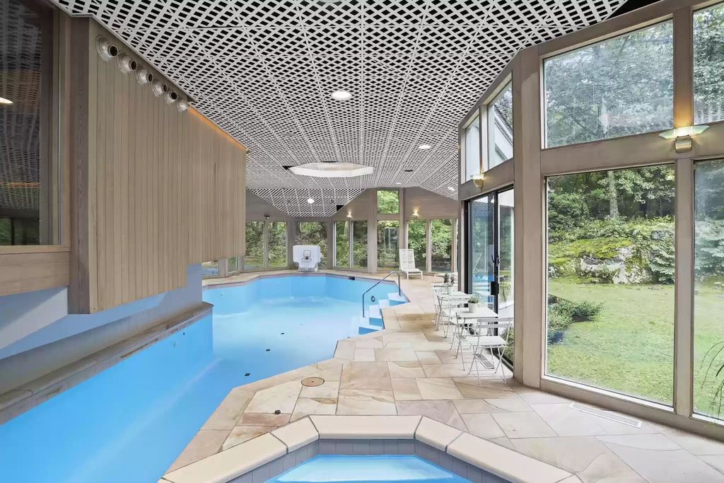 The House in Greenwich blends the verdant outdoors with open living spaces flooded with sunlight, now available for sale. This home located at 48 Lafrentz Rd, Greenwich, Connecticut