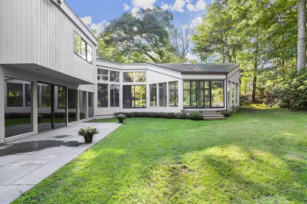 The House in Greenwich blends the verdant outdoors with open living spaces flooded with sunlight, now available for sale. This home located at 48 Lafrentz Rd, Greenwich, Connecticut