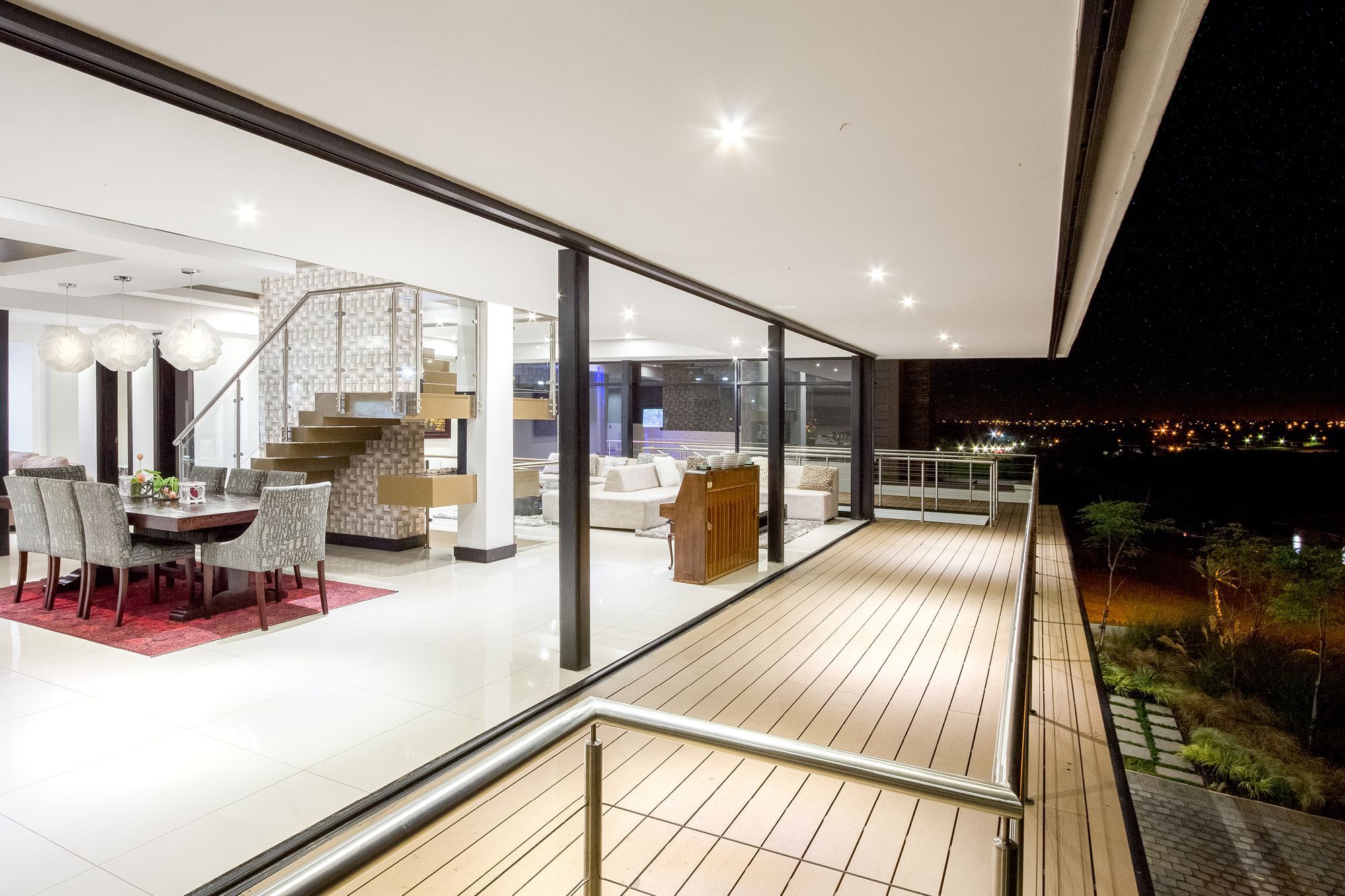Spread across three different levels, a central courtyard that flows into the rear garden and sparkling recessed lighting put the final touches on a South African home where outdoor living takes precedence.