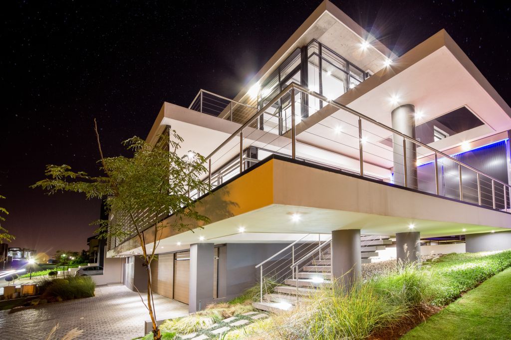 Spread across three different levels, a central courtyard that flows into the rear garden and sparkling recessed lighting put the final touches on a South African home where outdoor living takes precedence.