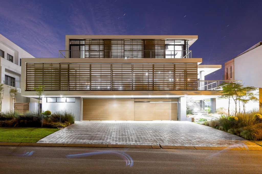 Spread across three different levels, a central courtyard that flows into the rear garden and sparkling recessed lighting put the final touches on a South African home where outdoor living takes precedence.