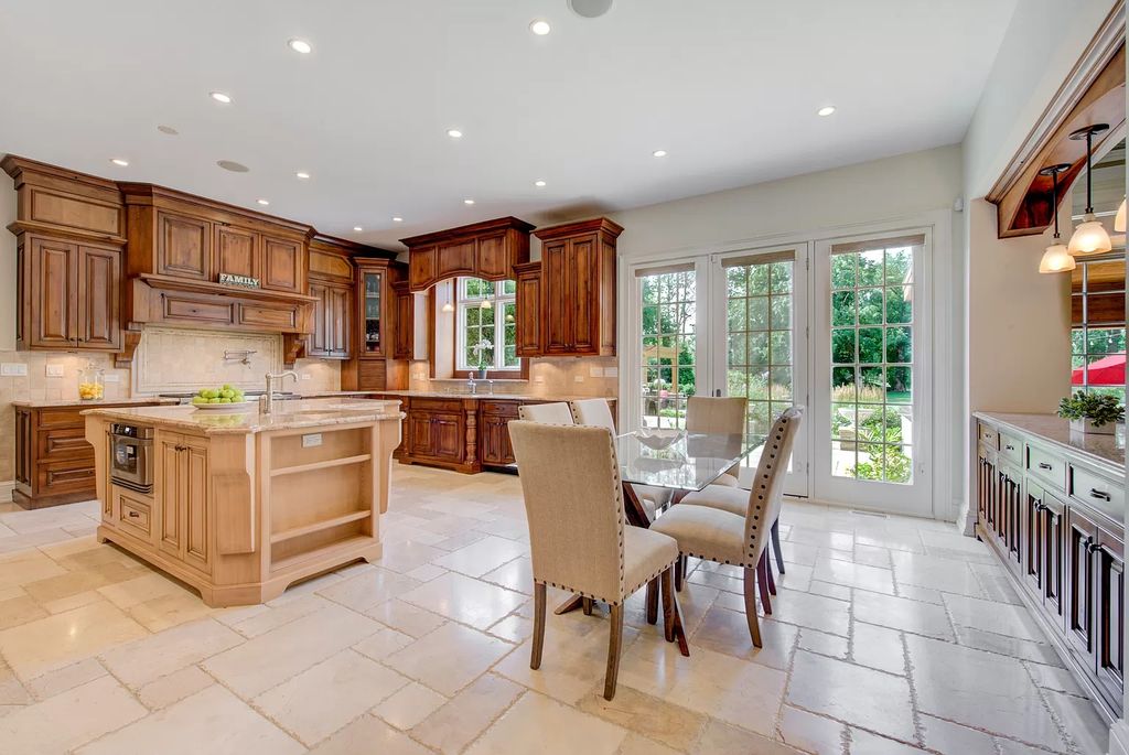The Home in Winnetka is surrounded with picturesque perennial flower and organic vegetable gardens, lush grounds, now available for sale. This home located at 102 Longmeadow Rd, Winnetka, Illinois