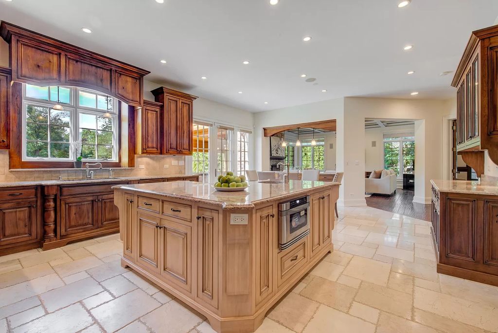 The Home in Winnetka is surrounded with picturesque perennial flower and organic vegetable gardens, lush grounds, now available for sale. This home located at 102 Longmeadow Rd, Winnetka, Illinois