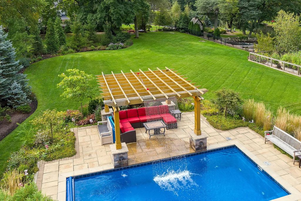 The Home in Winnetka is surrounded with picturesque perennial flower and organic vegetable gardens, lush grounds, now available for sale. This home located at 102 Longmeadow Rd, Winnetka, Illinois