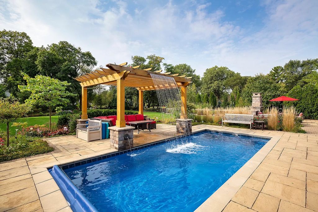 The Home in Winnetka is surrounded with picturesque perennial flower and organic vegetable gardens, lush grounds, now available for sale. This home located at 102 Longmeadow Rd, Winnetka, Illinois