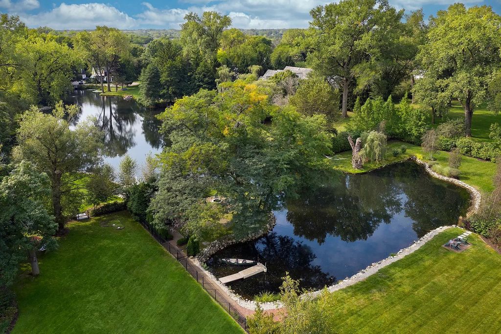 The Home in Winnetka is surrounded with picturesque perennial flower and organic vegetable gardens, lush grounds, now available for sale. This home located at 102 Longmeadow Rd, Winnetka, Illinois