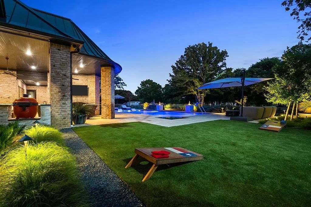 The Estate in Argyle, a stunning home with tranquil setting and a stocked pond offering outdoor oasis with ample covered area with fireplace and both a barbecue and smoker perfect for entertaining is now available for sale. This home located at 1000 Roadrunner Rd, Argyle, Texas