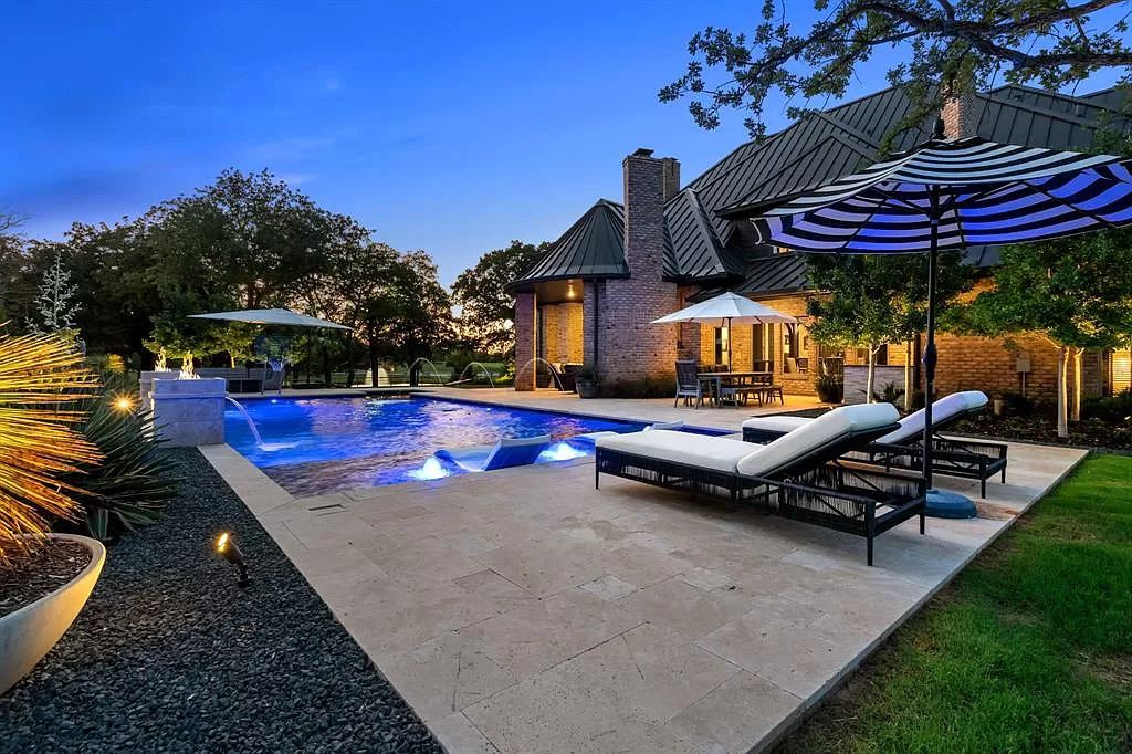 The Estate in Argyle, a stunning home with tranquil setting and a stocked pond offering outdoor oasis with ample covered area with fireplace and both a barbecue and smoker perfect for entertaining is now available for sale. This home located at 1000 Roadrunner Rd, Argyle, Texas