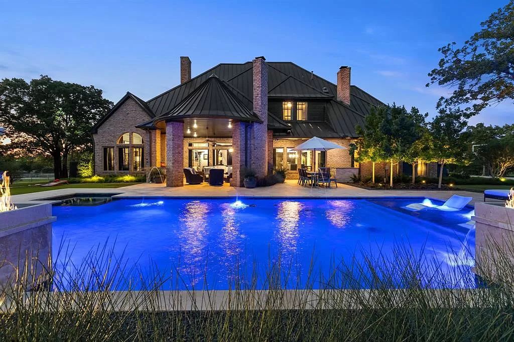 The Estate in Argyle, a stunning home with tranquil setting and a stocked pond offering outdoor oasis with ample covered area with fireplace and both a barbecue and smoker perfect for entertaining is now available for sale. This home located at 1000 Roadrunner Rd, Argyle, Texas