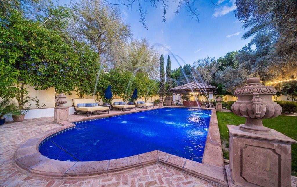 The Estate in Mesa, a an entertainer's dream designed for resort-like living with over 14,000 square feet of pure luxury offering a lush formally landscaped sanctuary and countless amenities is now available for sale. This home located at 1550 N 40th St UNIT 14, Mesa, Arizona