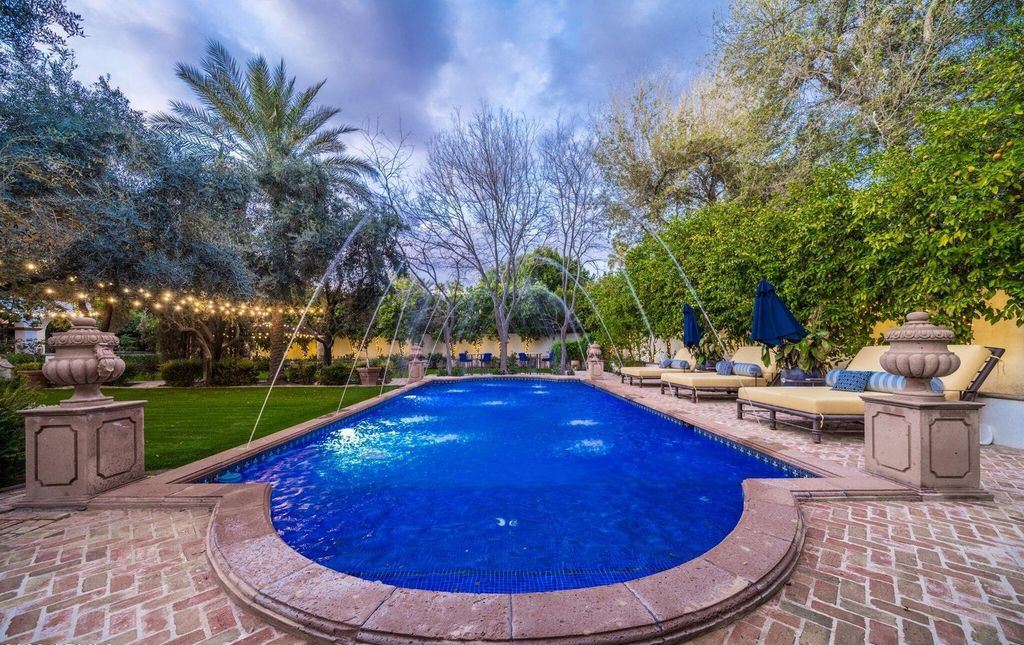 The Estate in Mesa, a an entertainer's dream designed for resort-like living with over 14,000 square feet of pure luxury offering a lush formally landscaped sanctuary and countless amenities is now available for sale. This home located at 1550 N 40th St UNIT 14, Mesa, Arizona