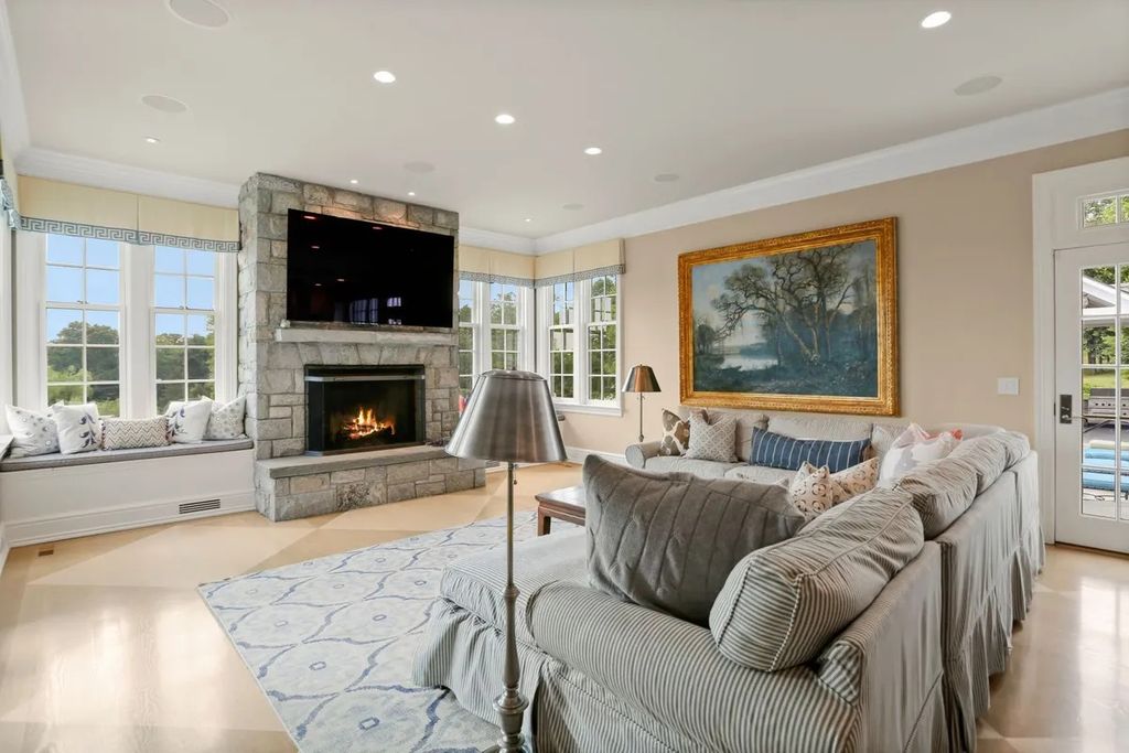 The Manor in Greenwich offers beautiful infinity pool and spa with a pool house, indoor and outdoor showers and outdoor kitchen, now available for sale. This home located at 59 Mooreland Rd, Greenwich, Connecticut