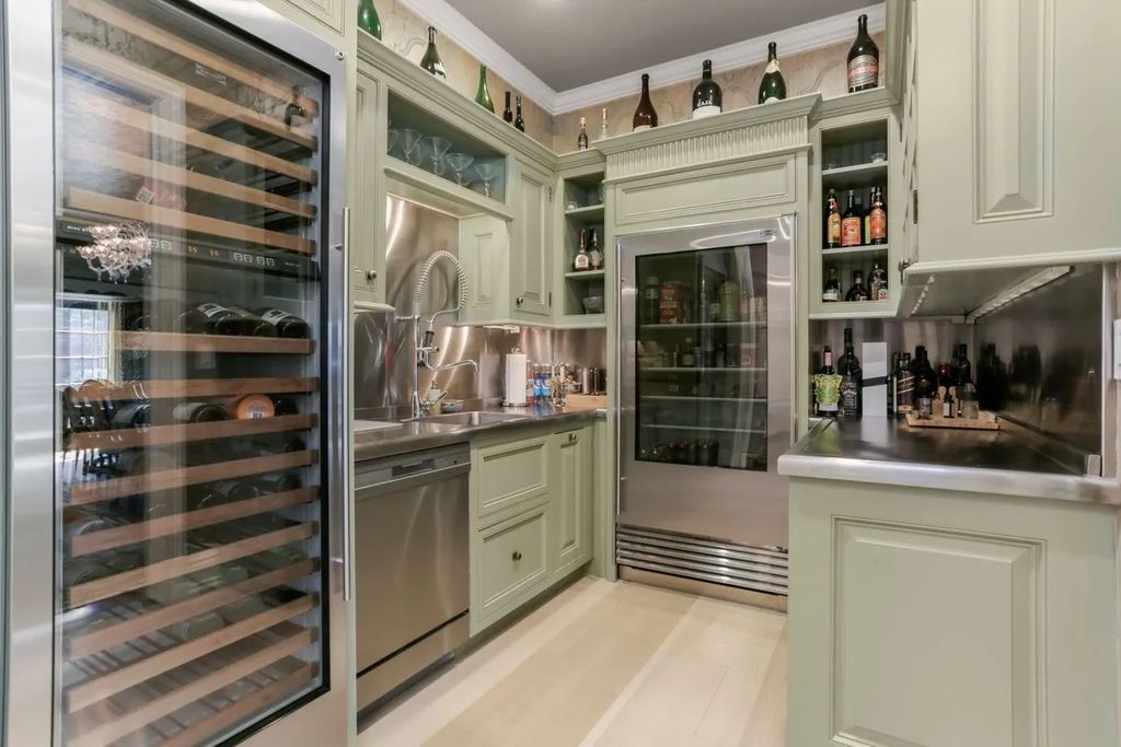 The Manor in Greenwich offers beautiful infinity pool and spa with a pool house, indoor and outdoor showers and outdoor kitchen, now available for sale. This home located at 59 Mooreland Rd, Greenwich, Connecticut