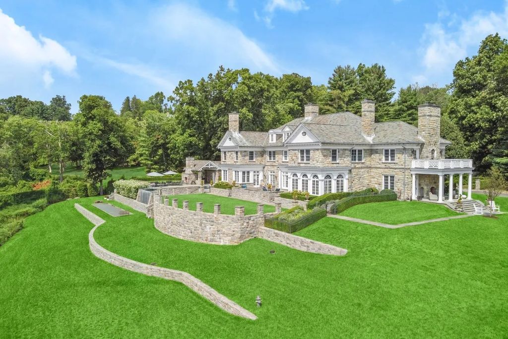 The Manor in Greenwich offers beautiful infinity pool and spa with a pool house, indoor and outdoor showers and outdoor kitchen, now available for sale. This home located at 59 Mooreland Rd, Greenwich, Connecticut