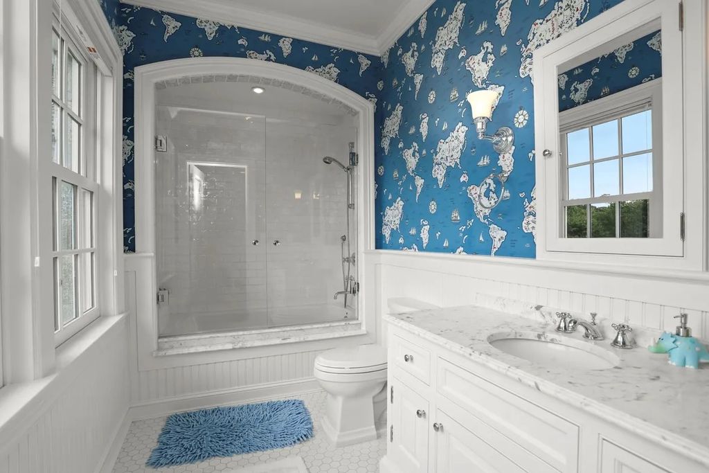 The Manor in Greenwich offers beautiful infinity pool and spa with a pool house, indoor and outdoor showers and outdoor kitchen, now available for sale. This home located at 59 Mooreland Rd, Greenwich, Connecticut
