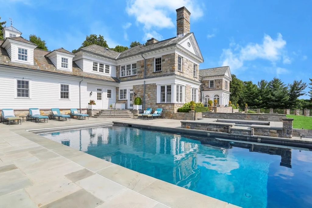 The Manor in Greenwich offers beautiful infinity pool and spa with a pool house, indoor and outdoor showers and outdoor kitchen, now available for sale. This home located at 59 Mooreland Rd, Greenwich, Connecticut