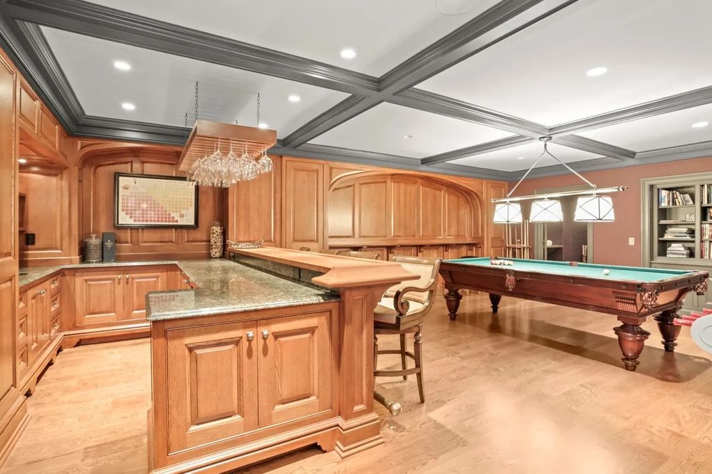 The Manor in Greenwich offers beautiful infinity pool and spa with a pool house, indoor and outdoor showers and outdoor kitchen, now available for sale. This home located at 59 Mooreland Rd, Greenwich, Connecticut