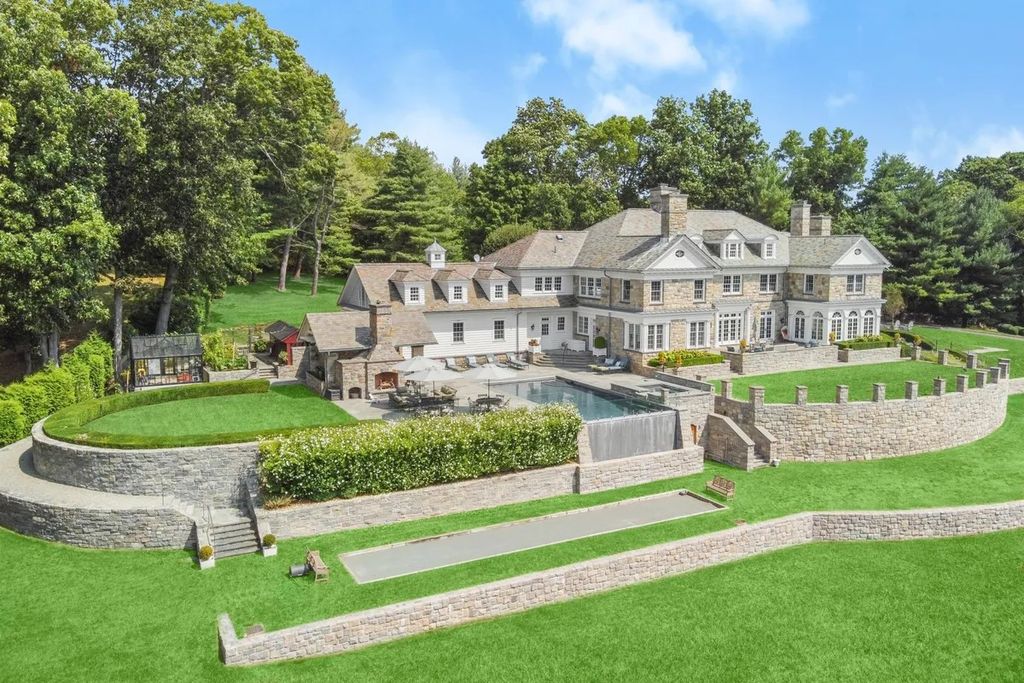 The Manor in Greenwich offers beautiful infinity pool and spa with a pool house, indoor and outdoor showers and outdoor kitchen, now available for sale. This home located at 59 Mooreland Rd, Greenwich, Connecticut
