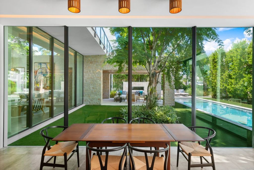 121 Nurmi Dr, Fort Lauderdale, Florida is a sophisticated modernist estate built in 2020 by renown architect Daniel Kahan from Smith and Moore with unbelievable features including beautiful lighting, private gardens, summer kitchen and more.