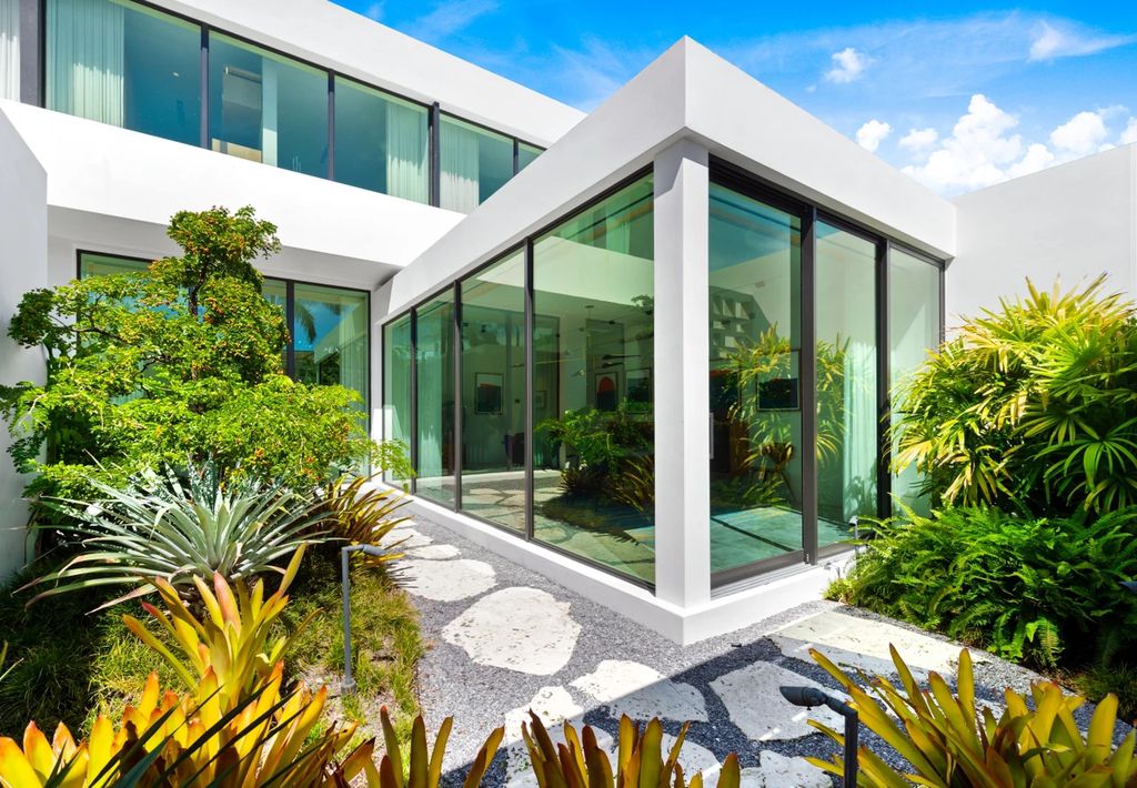 121 Nurmi Dr, Fort Lauderdale, Florida is a sophisticated modernist estate built in 2020 by renown architect Daniel Kahan from Smith and Moore with unbelievable features including beautiful lighting, private gardens, summer kitchen and more.