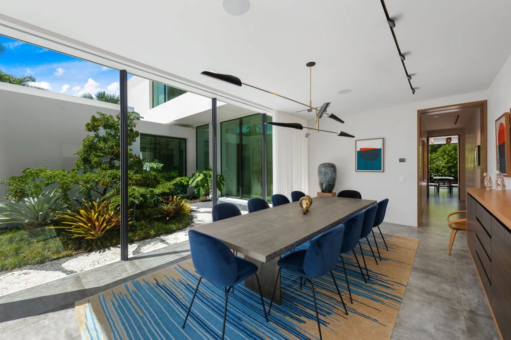 121 Nurmi Dr, Fort Lauderdale, Florida is a sophisticated modernist estate built in 2020 by renown architect Daniel Kahan from Smith and Moore with unbelievable features including beautiful lighting, private gardens, summer kitchen and more.