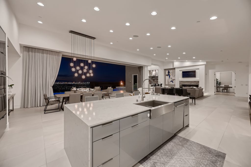 The Home in Henderson, a MacDonald Highlands residence offers a bright and open floor plan, an amazing backyard with infinity edge pool, spa, outdoor kitchen with bbq, fire pit and lounge area is now available for sale. This home located at 667 Palisade Rim Dr, Henderson, Nevada