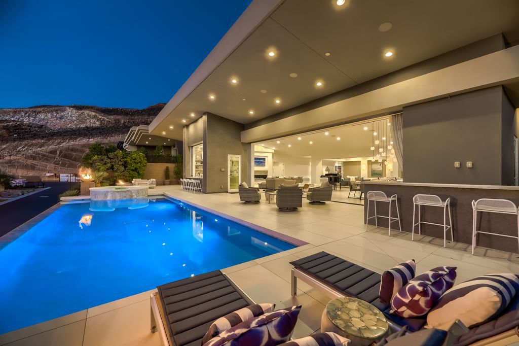 The Home in Henderson, a MacDonald Highlands residence offers a bright and open floor plan, an amazing backyard with infinity edge pool, spa, outdoor kitchen with bbq, fire pit and lounge area is now available for sale. This home located at 667 Palisade Rim Dr, Henderson, Nevada