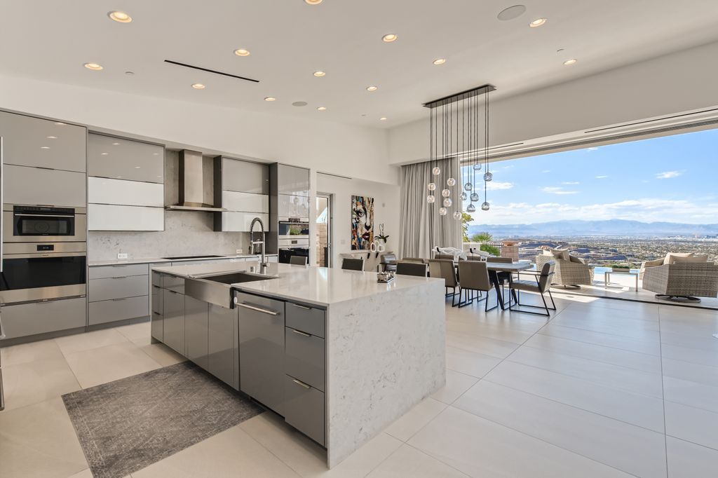 The Home in Henderson, a MacDonald Highlands residence offers a bright and open floor plan, an amazing backyard with infinity edge pool, spa, outdoor kitchen with bbq, fire pit and lounge area is now available for sale. This home located at 667 Palisade Rim Dr, Henderson, Nevada