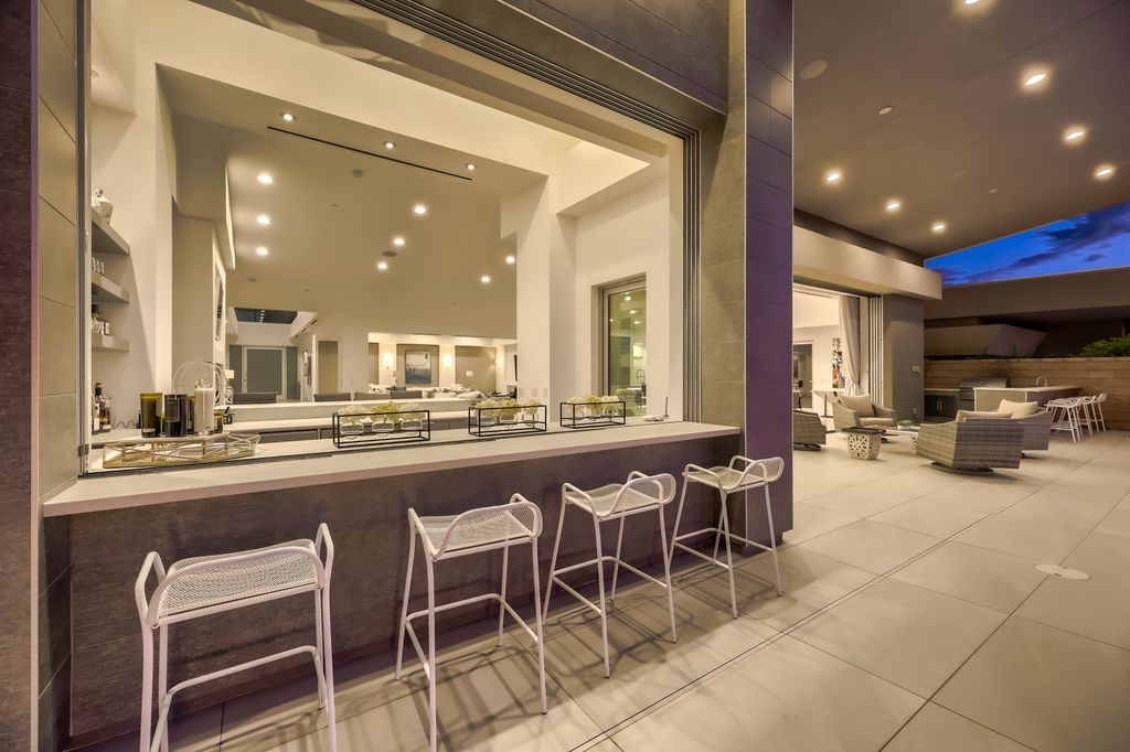 The Home in Henderson, a MacDonald Highlands residence offers a bright and open floor plan, an amazing backyard with infinity edge pool, spa, outdoor kitchen with bbq, fire pit and lounge area is now available for sale. This home located at 667 Palisade Rim Dr, Henderson, Nevada