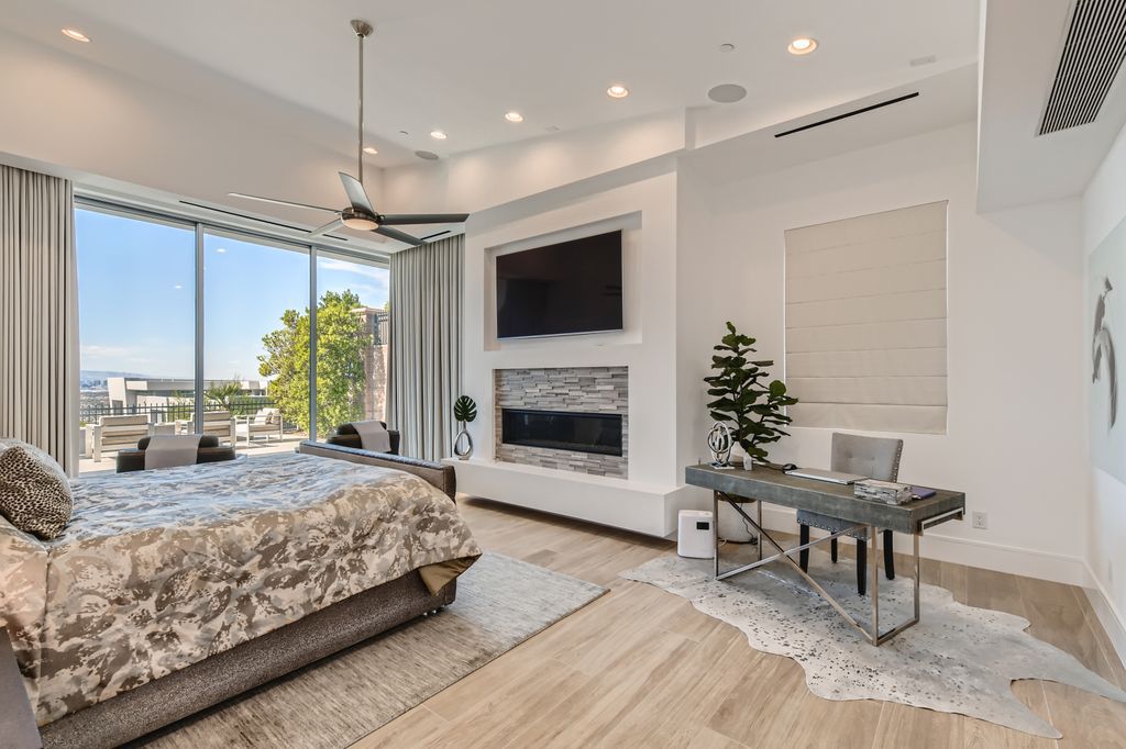 The Home in Henderson, a MacDonald Highlands residence offers a bright and open floor plan, an amazing backyard with infinity edge pool, spa, outdoor kitchen with bbq, fire pit and lounge area is now available for sale. This home located at 667 Palisade Rim Dr, Henderson, Nevada