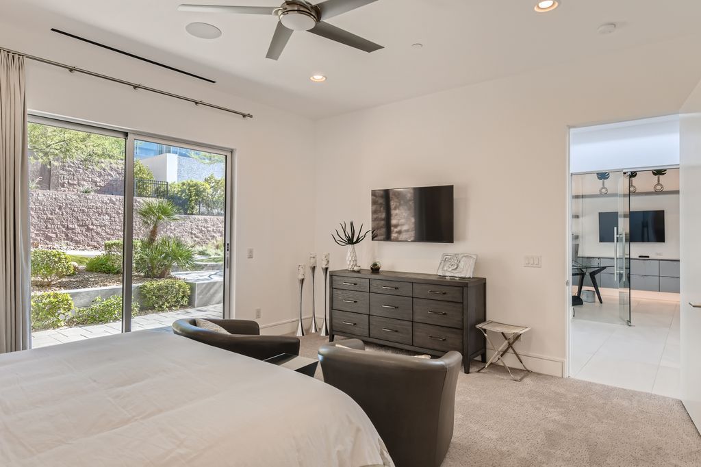 The Home in Henderson, a MacDonald Highlands residence offers a bright and open floor plan, an amazing backyard with infinity edge pool, spa, outdoor kitchen with bbq, fire pit and lounge area is now available for sale. This home located at 667 Palisade Rim Dr, Henderson, Nevada
