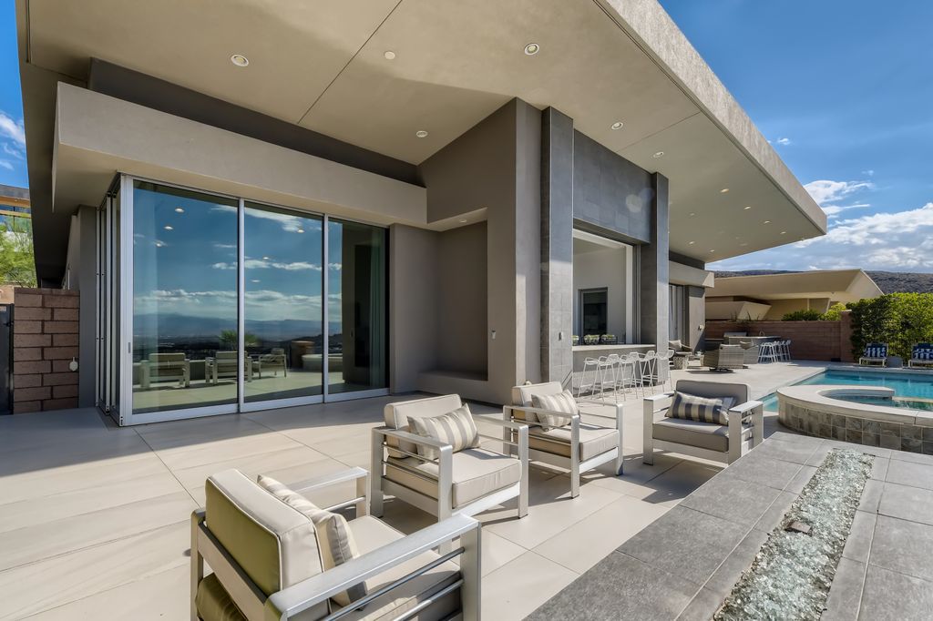 The Home in Henderson, a MacDonald Highlands residence offers a bright and open floor plan, an amazing backyard with infinity edge pool, spa, outdoor kitchen with bbq, fire pit and lounge area is now available for sale. This home located at 667 Palisade Rim Dr, Henderson, Nevada