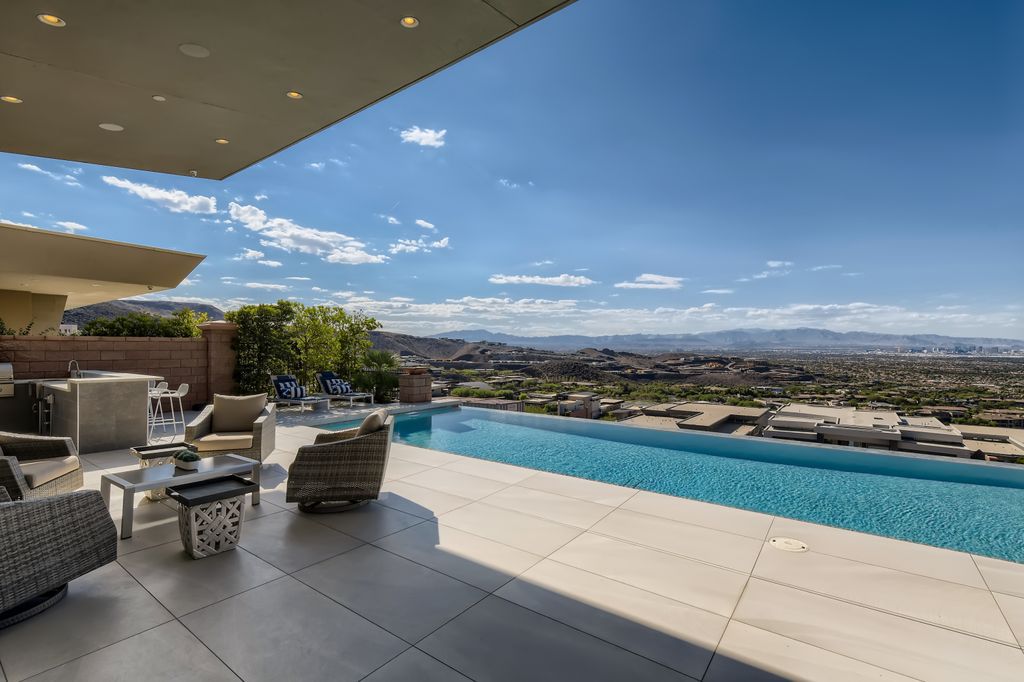The Home in Henderson, a MacDonald Highlands residence offers a bright and open floor plan, an amazing backyard with infinity edge pool, spa, outdoor kitchen with bbq, fire pit and lounge area is now available for sale. This home located at 667 Palisade Rim Dr, Henderson, Nevada
