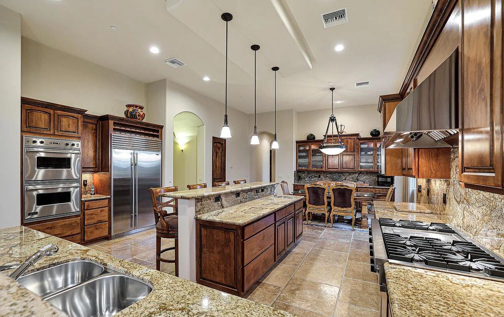 The Home in Scottsdale, a custom estate sitting on 2.78 acres in gated Sonoran Crest with details including box-beam, coffered and groin vault ceiling details, travertine stone flooring, granite counter surfaces, richly stained wood doors, trim, and cabinetry, a split floor plan and so much more is now available for sale. This home located at 24375 N 121st Pl, Scottsdale, Arizona