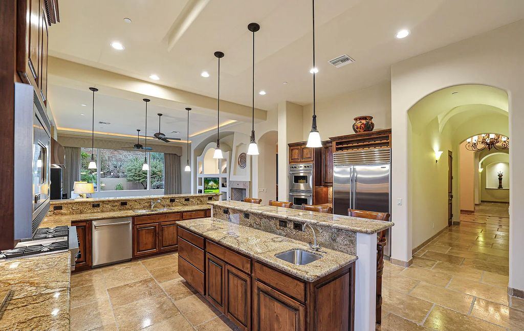 The Home in Scottsdale, a custom estate sitting on 2.78 acres in gated Sonoran Crest with details including box-beam, coffered and groin vault ceiling details, travertine stone flooring, granite counter surfaces, richly stained wood doors, trim, and cabinetry, a split floor plan and so much more is now available for sale. This home located at 24375 N 121st Pl, Scottsdale, Arizona