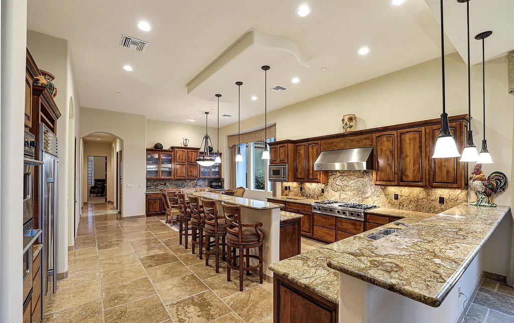 The Home in Scottsdale, a custom estate sitting on 2.78 acres in gated Sonoran Crest with details including box-beam, coffered and groin vault ceiling details, travertine stone flooring, granite counter surfaces, richly stained wood doors, trim, and cabinetry, a split floor plan and so much more is now available for sale. This home located at 24375 N 121st Pl, Scottsdale, Arizona